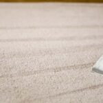 This is a photo of a carpet steam cleaner cleaning a cream carpet works carried out by Purley Carpet Cleaning Solutions.