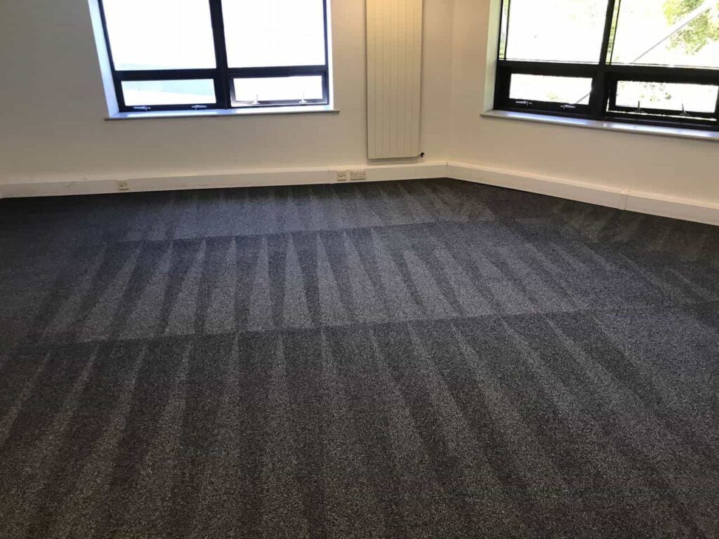 This is a photo of a grey office carpet that has just been professionally steam cleaned works carried out by Purley Carpet Cleaning Solutions.